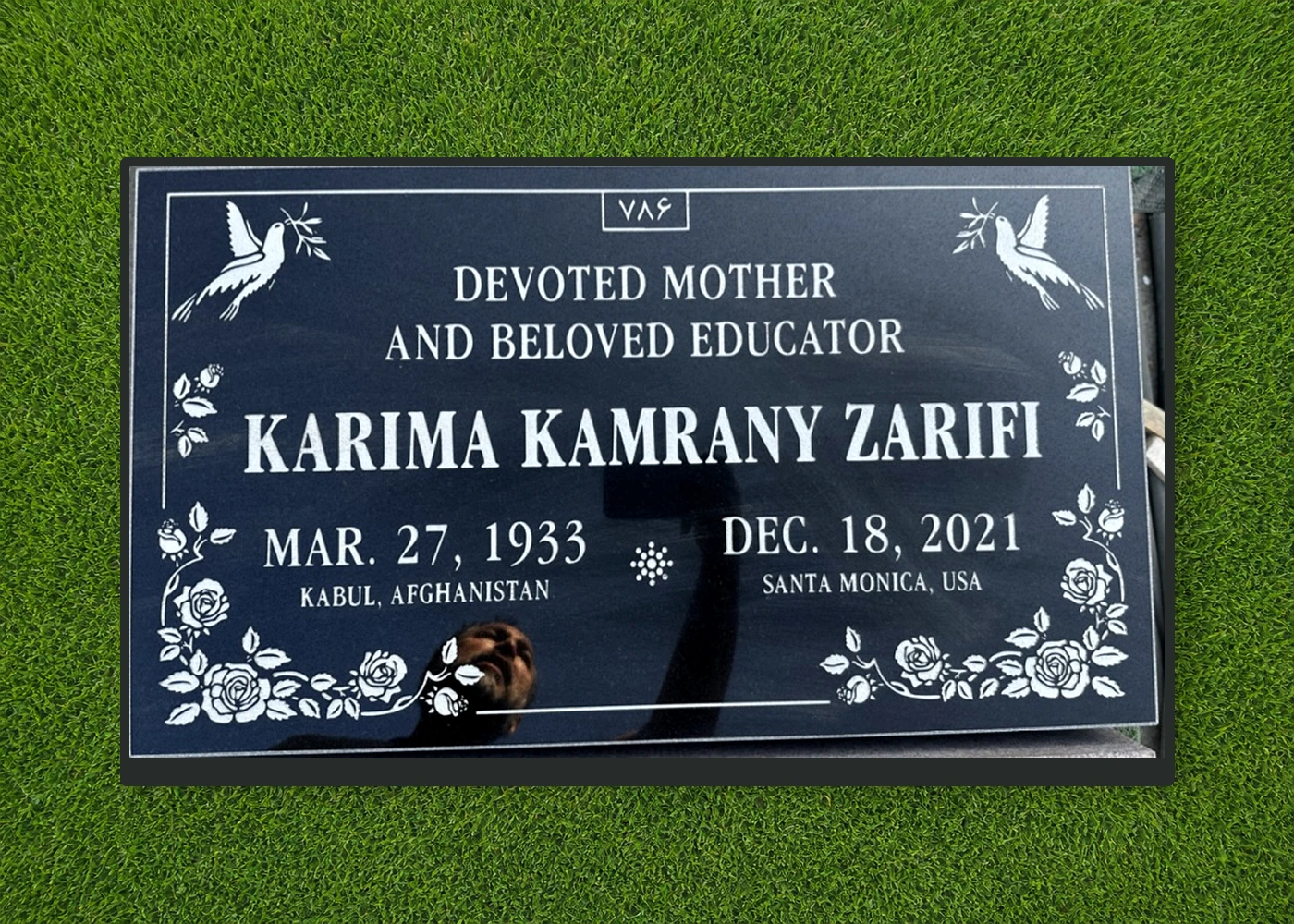 Black granite 28 by 16 inch flat marker with floral and bird engraving