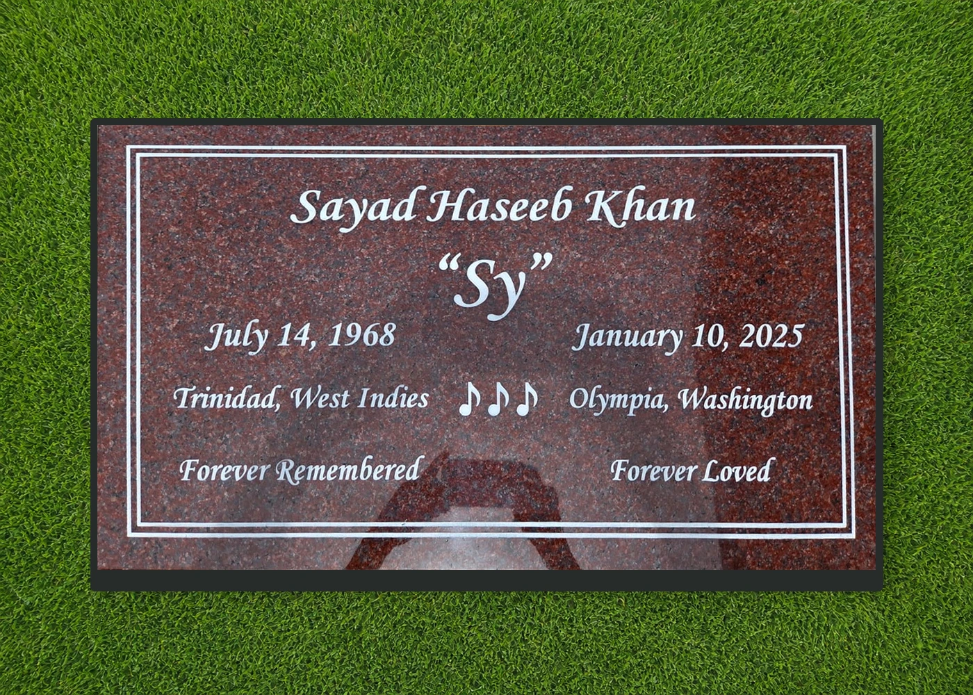 Red granite 28 by 16 inch marker with musical notes